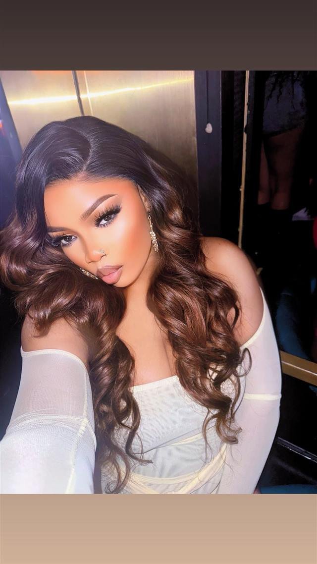 Soft-lit portrait with long brown waves